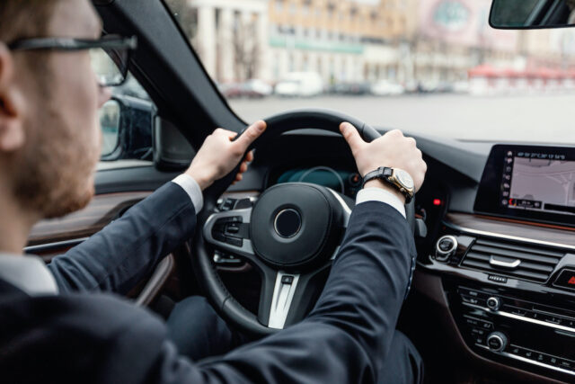 man driving car