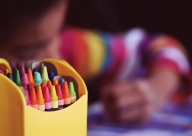 child drawing crayons